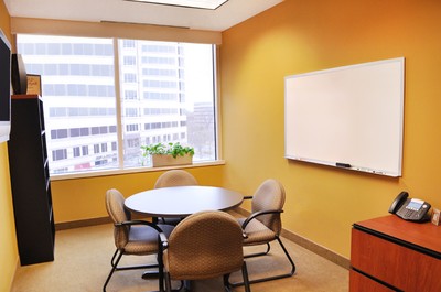 Office with table and four chairs.