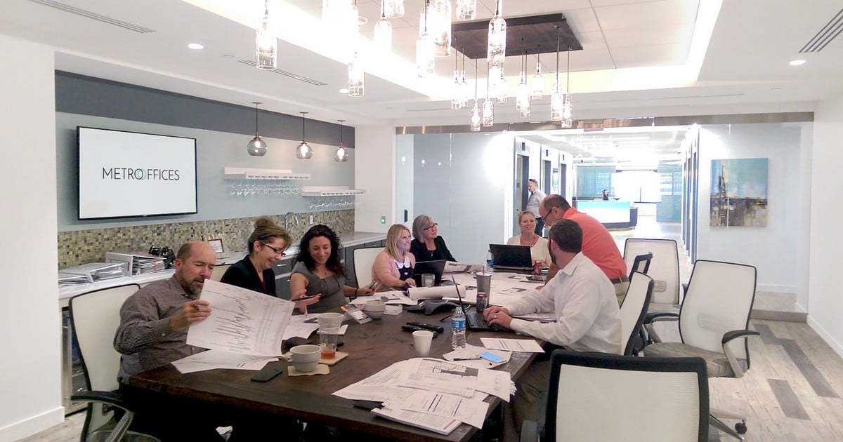 Group of colleagues around a large conference table.