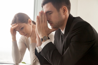 A man and woman appearing frustrated.