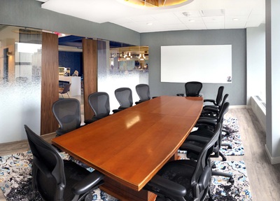 Large conference room with black chairs.