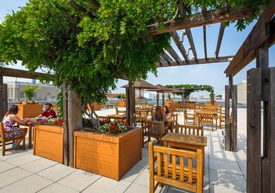 Open space outdoors with tables and trellis.
