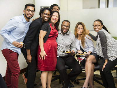 Office workers posing for a group photo.