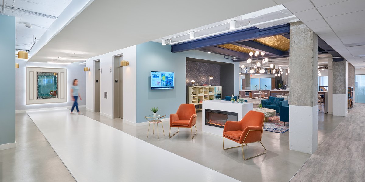 Open office space with chairs, and reception area.