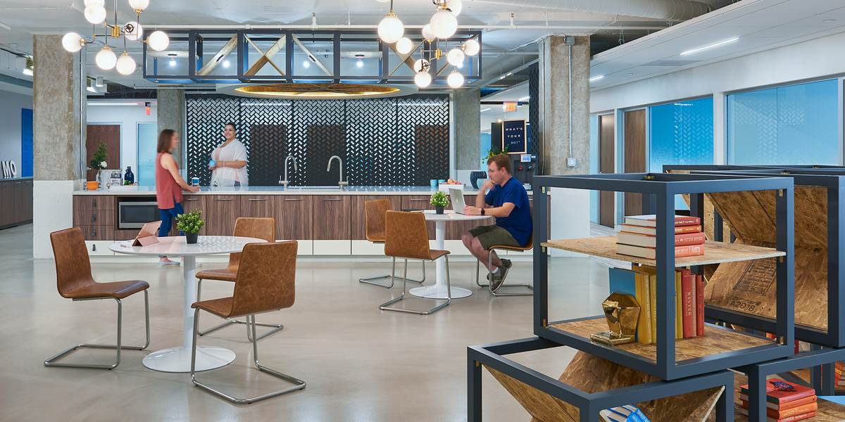 Open office space with round tables and chairs.